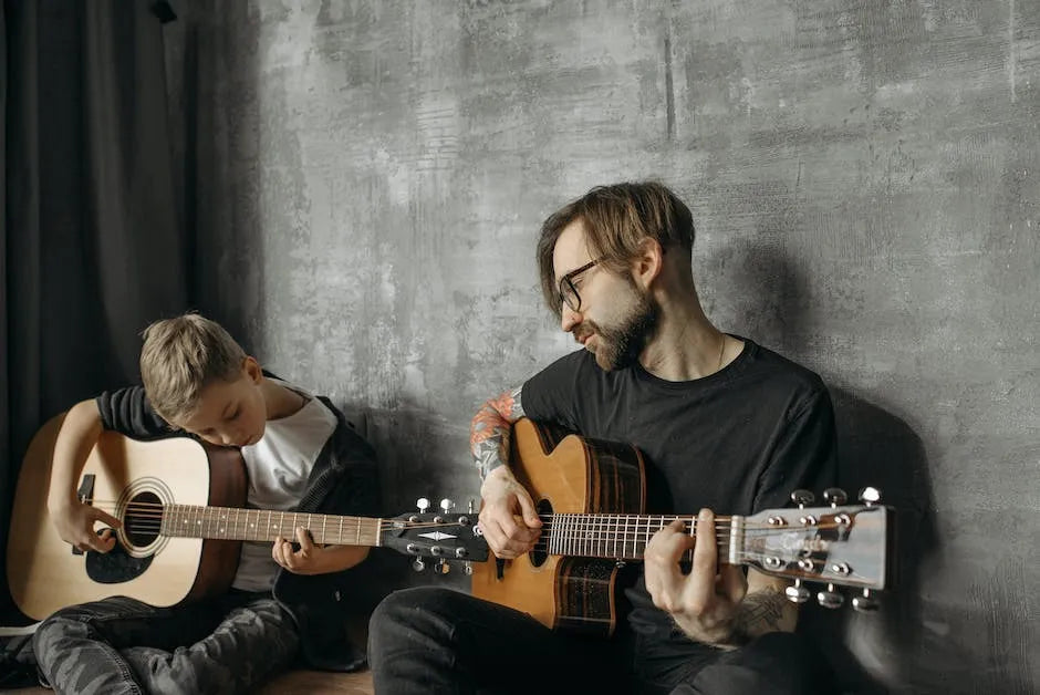 man and son playing guitar