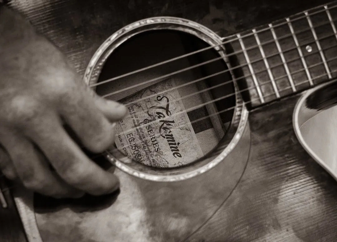 close up of guitar being strummed