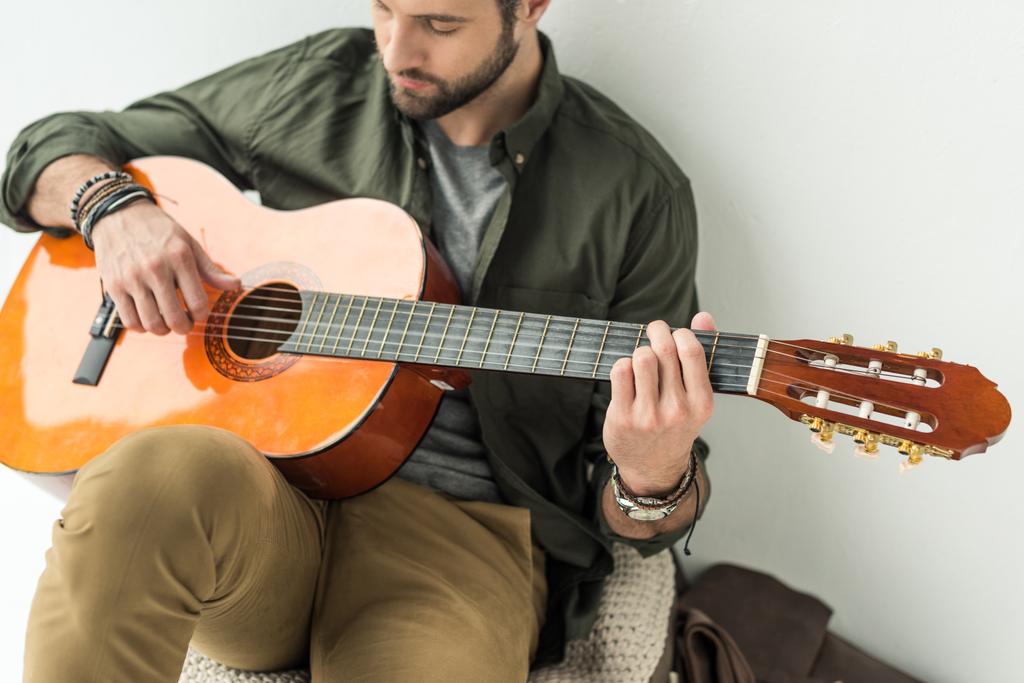 man playing classical guitar