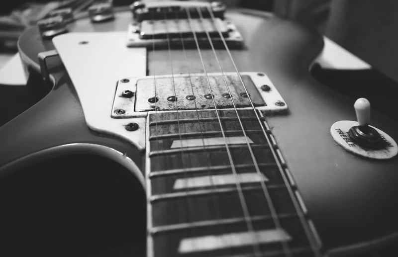 Black and white photo of a Les Paul style guitar