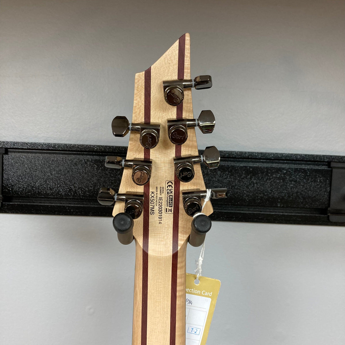 Cort KX507 SDG 7-String Multi-Scale electric guitar with labeled neck, showcasing advanced hardware and multiple fret structures for enhanced playability.