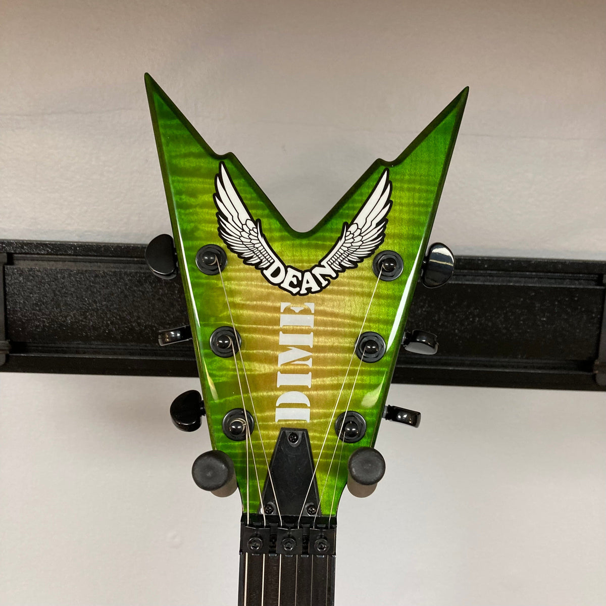 Dean Stealth Floyd FM Dime Slime guitar with Flame Maple top, Ebony fretboard with Pearl inlays, and Floyd Rose bridge, displayed in a hardshell case.