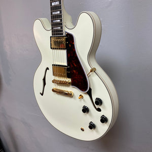 Epiphone IGC 1959 ES-355 Classic White Electric Guitar with gold hardware and detailed inlay work, displayed on a wall.