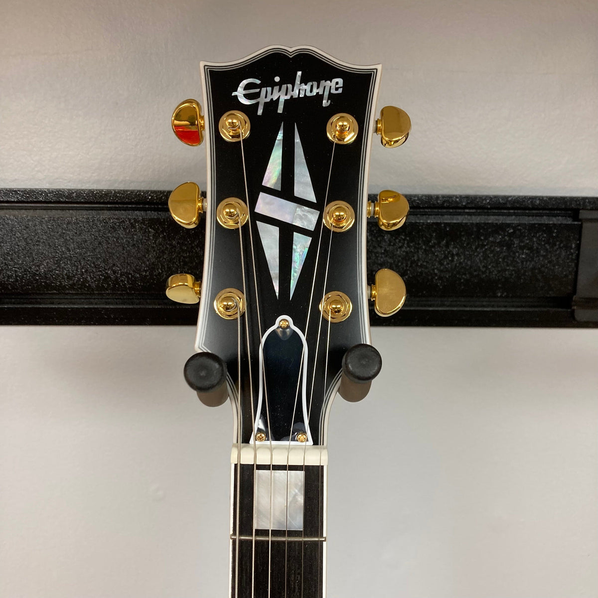 Epiphone 1959 ES-355 Classic White Electric Guitar with gold knobs and detailed inlay work on the neck.