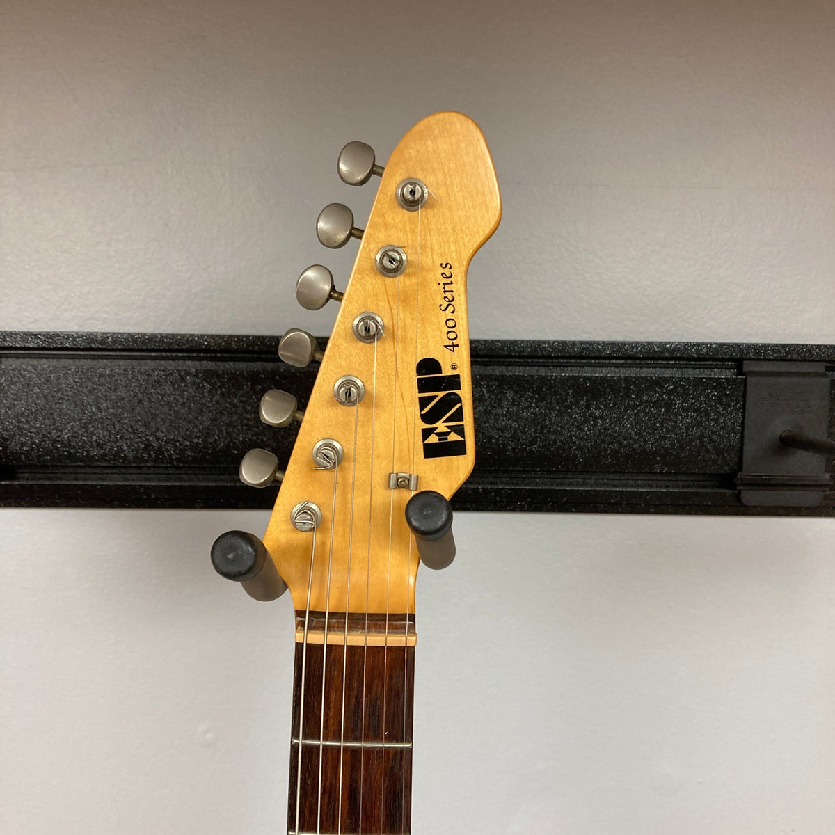 ESP Japan 400 Series Strat style guitar on stand, showcasing its detailed craftsmanship, includes a case; ideal for musicians seeking quality and precision.