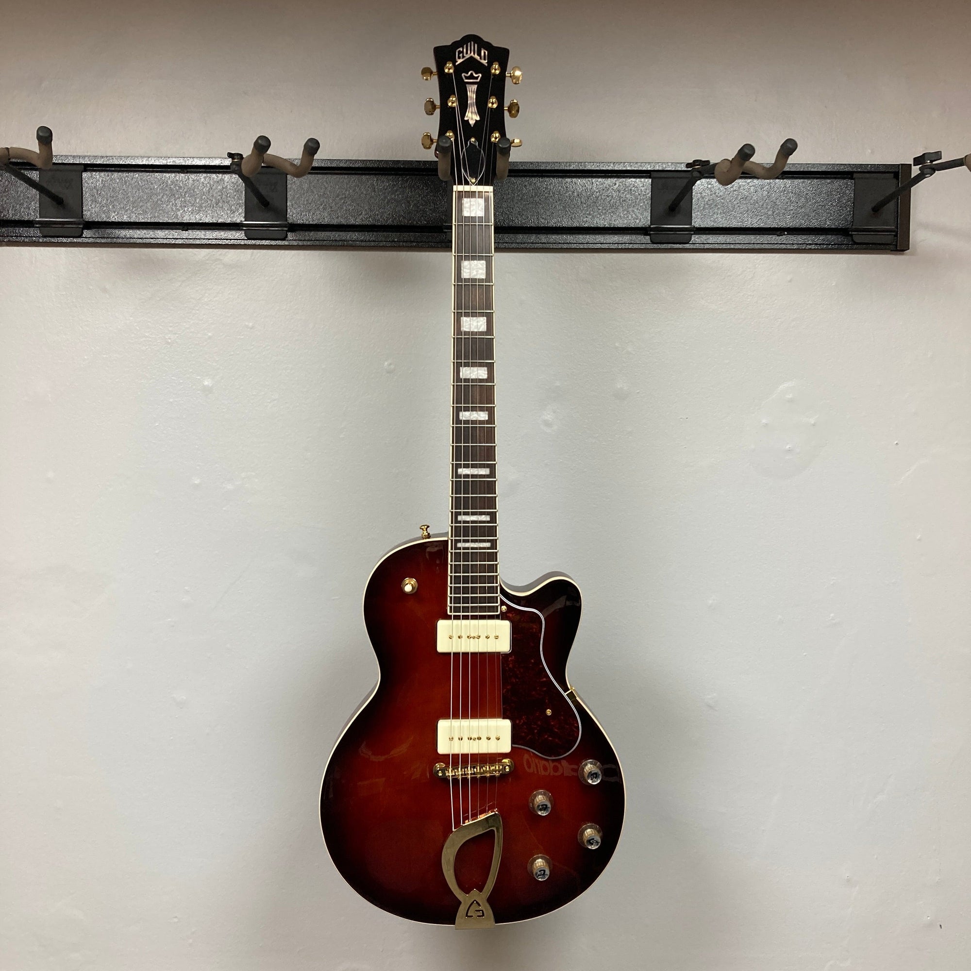 Guild Aristocrat P90 Consign electric guitar, showcasing its strings and knobs. Ideal for music lovers, available at Guitars on Main.