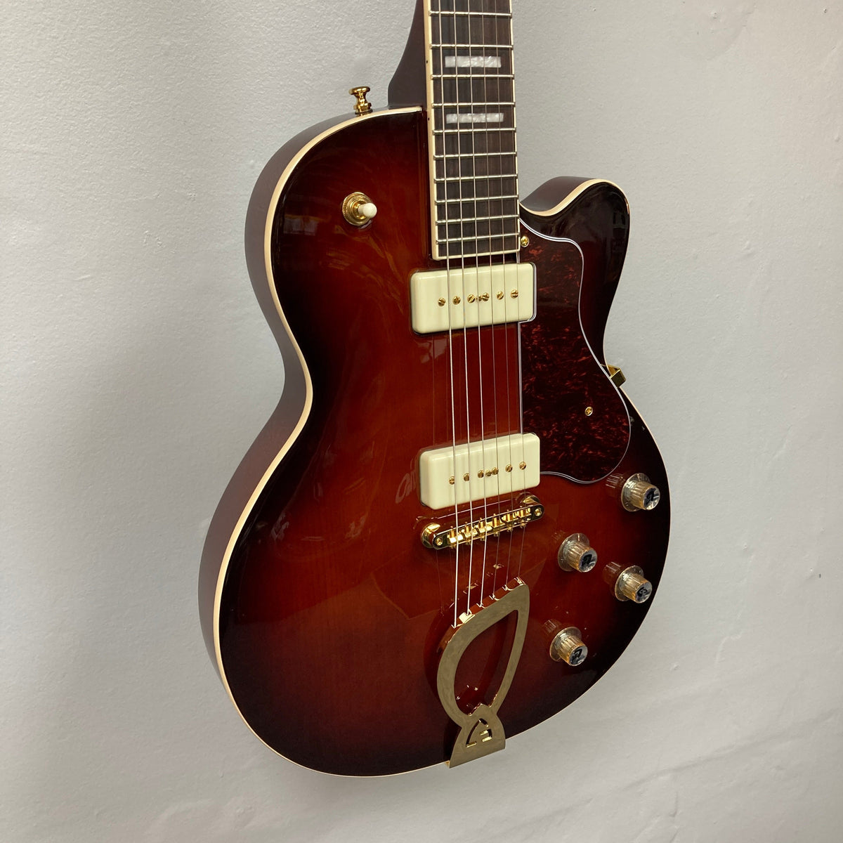 Guild Aristocrat P90 Consign electric guitar displayed vertically, showcasing its strings and body design, ideal for music enthusiasts and collectors.