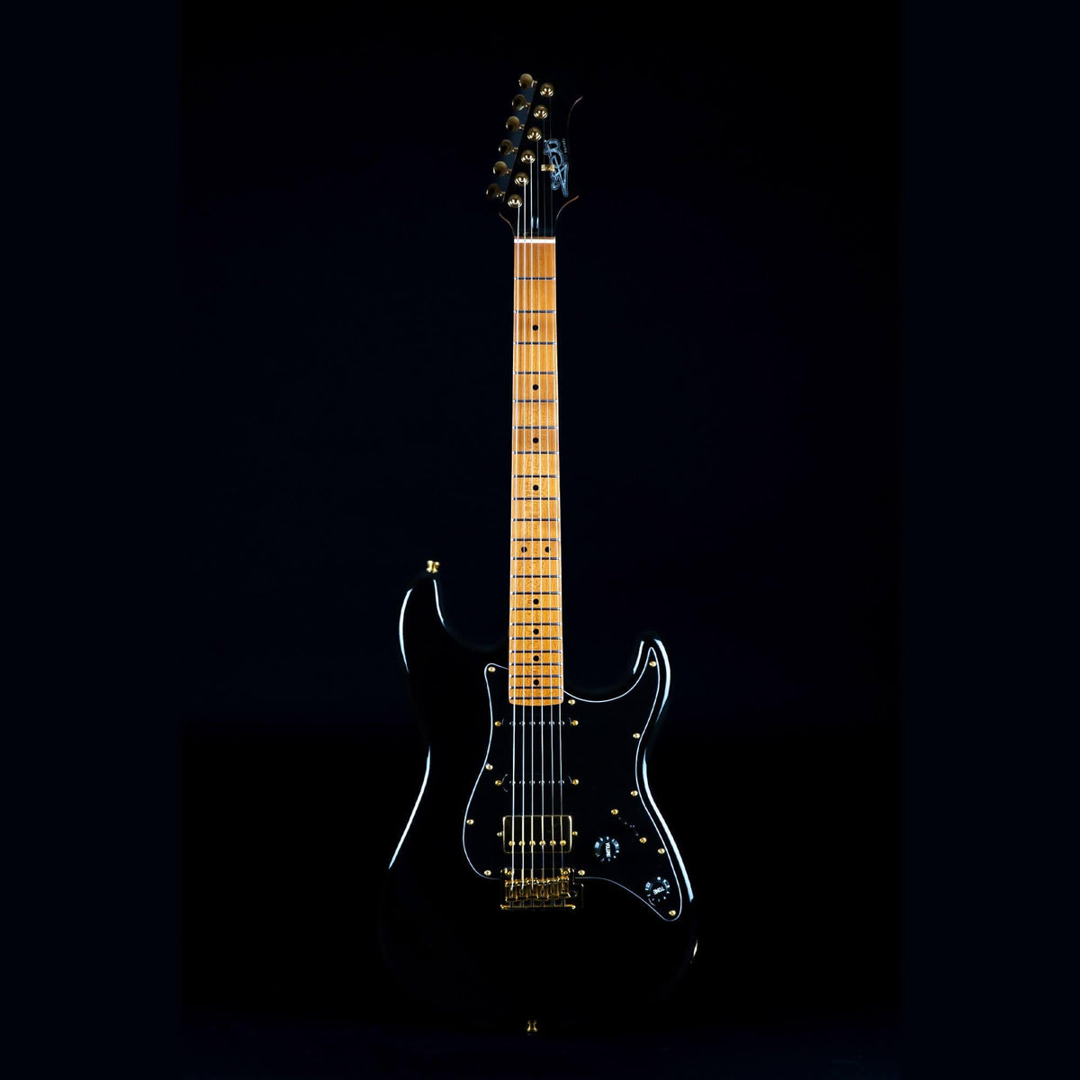 Jet JS-400 black electric guitar with gold accents, featuring a modern C-shaped neck and HSS pickup for versatile tones.