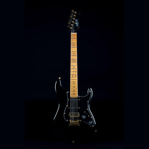 Jet JS-400 black electric guitar with gold accents, featuring a modern C-shaped neck and HSS pickup for versatile tones.