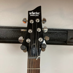 Schecter C-6 Plus Charcoal Burst Used electric guitar headstock with silver knobs, showcasing part of the neck and tuning pegs.