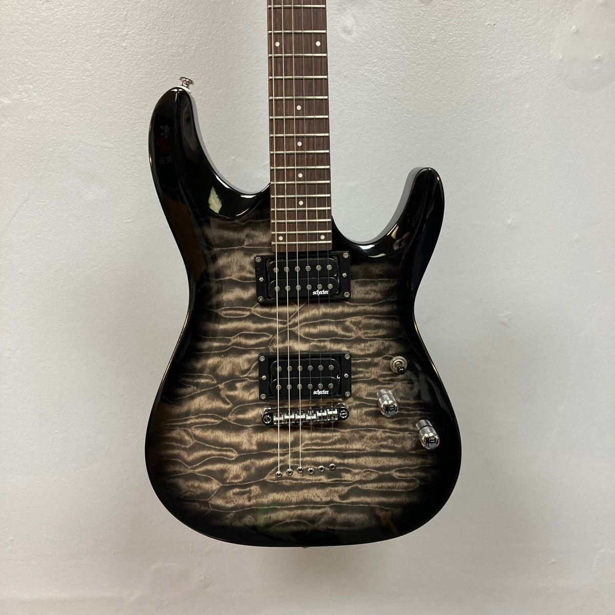 Schecter C-6 Plus Electric Guitar featuring a sleek design, rosewood fingerboard with 24 jumbo frets, and Schecter open-coil humbuckers for powerful sound.