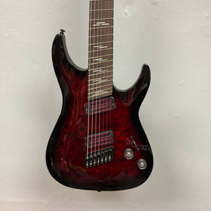 Schecter Omen Elite-7 Multiscale electric guitar, Black Cherry Burst finish, showcasing 7-string playability, jumbo frets, and humbucker pickups with some finish blemishes.