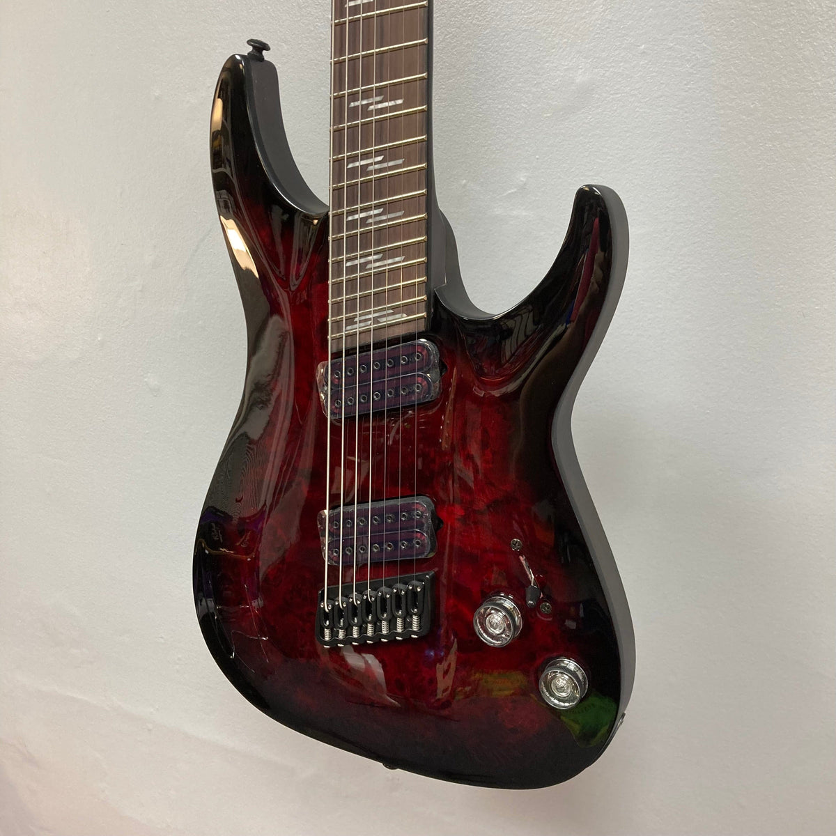 Schecter Omen Elite-7 Multiscale Black Cherry Burst Blem, showcasing close-up of guitar strings and body, highlighting finish blemishes and premium build features.