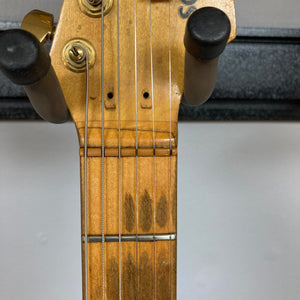 Schecter USA Super Strat 1983-1987 Black Gold, close-up of guitar body and strings, showcasing its detailed craftsmanship and design.