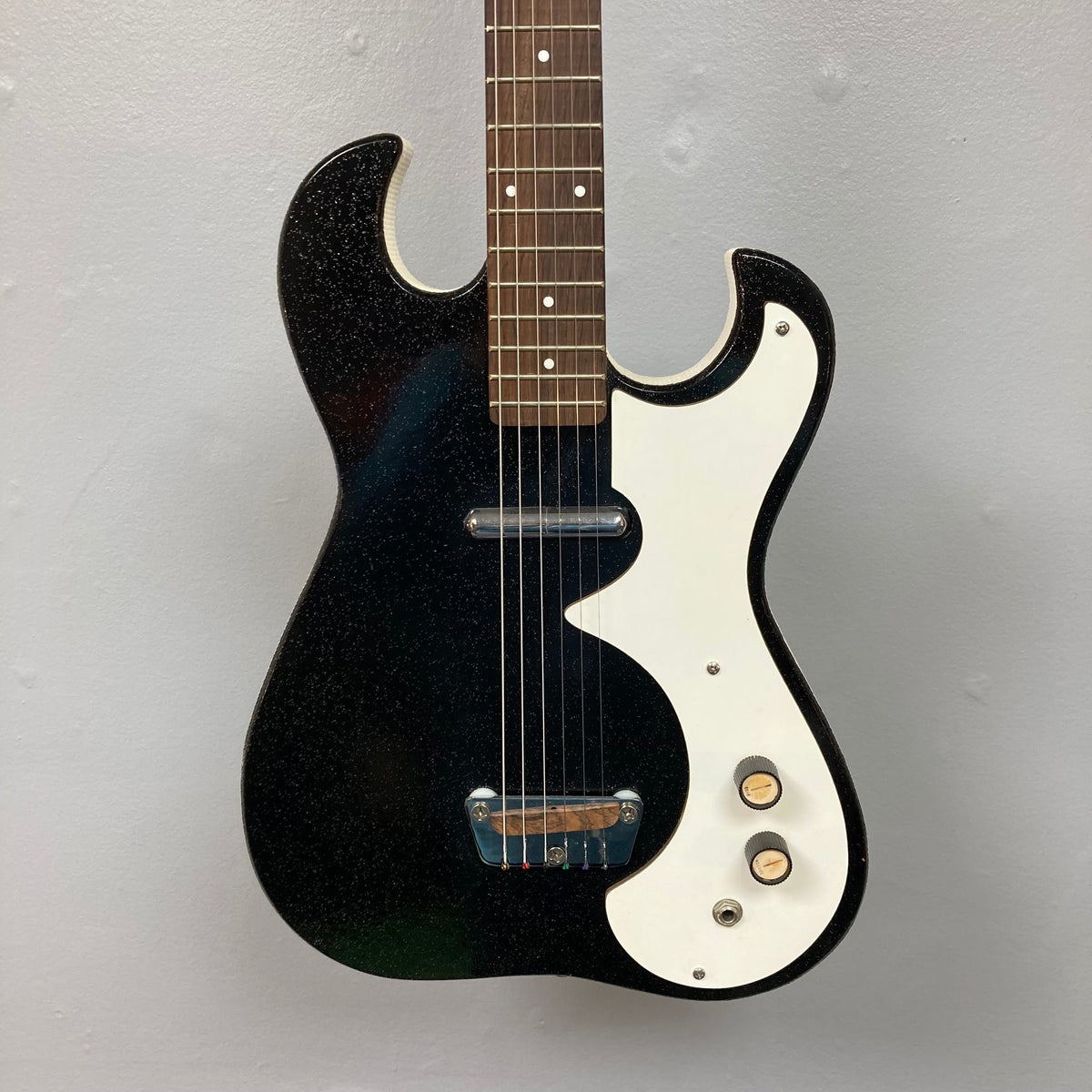 Sears Silvertone 1448 1960s Black Sparkle electric guitar with case featuring built-in tube amp and single lipstick-style pickup.