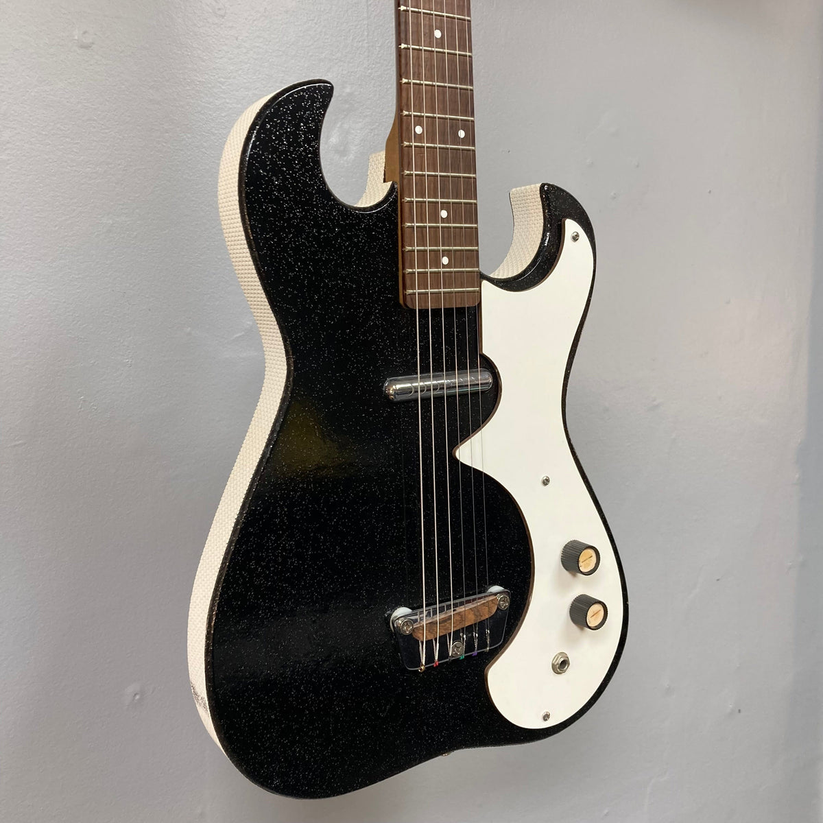 Sears Silvertone 1448 1960s Black Sparkle guitar with built-in amp case, showcasing its vintage design and single lipstick-style pickup.