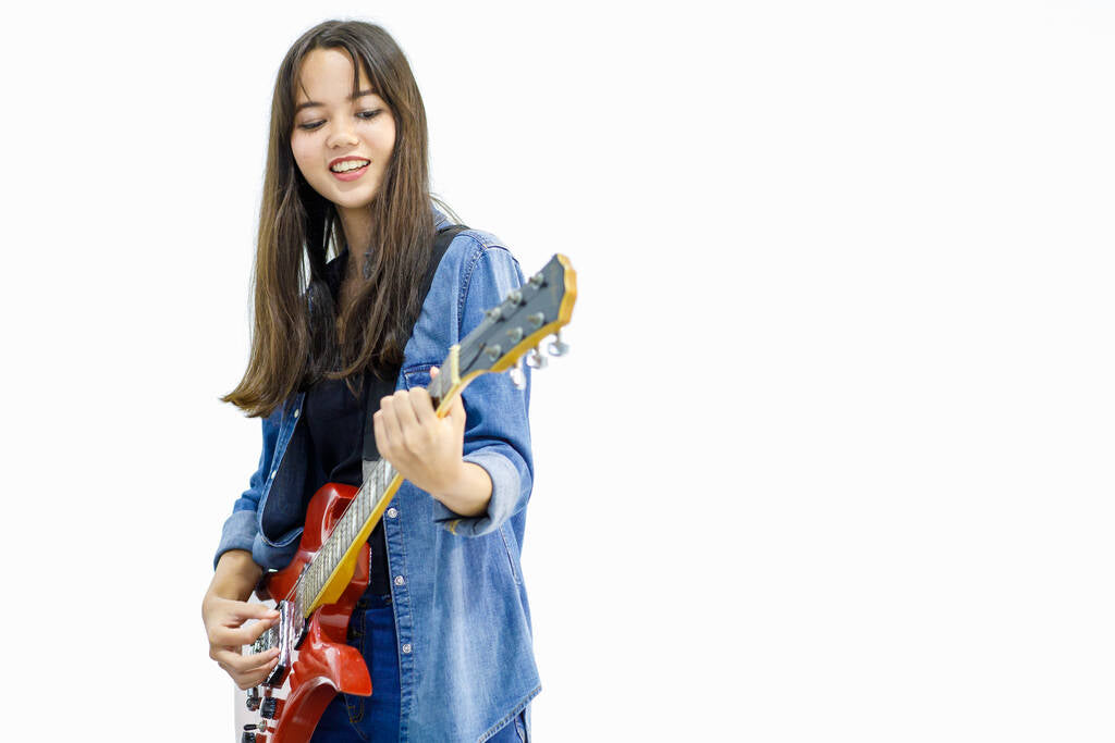 A young woman playing guitar.