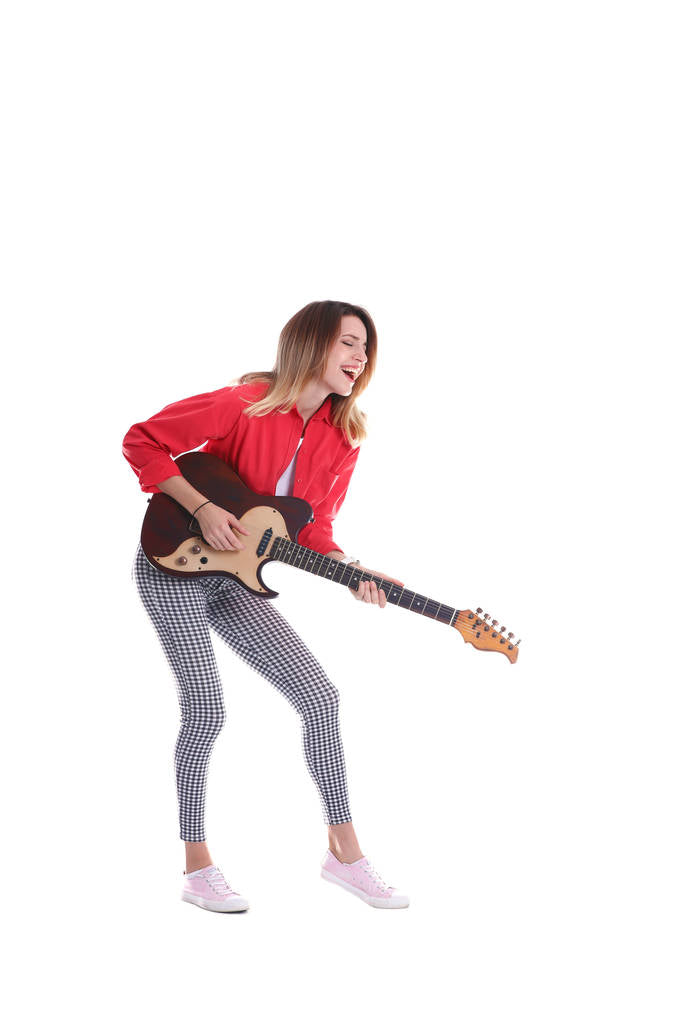 A young woman playing an electric guitar.