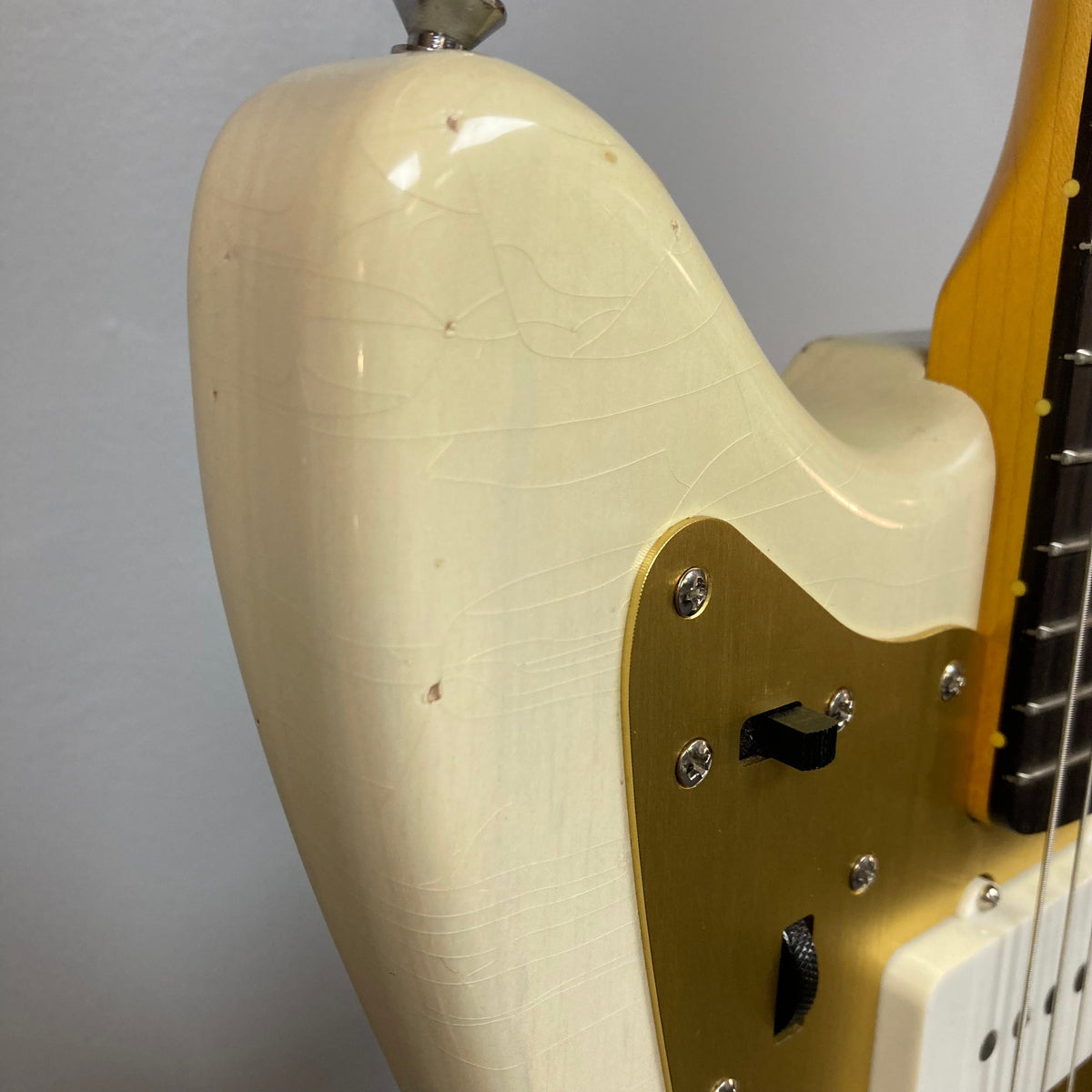 TopHat 59 Jazzavarius Blonde See Through Relic, close-up of white and gold electric guitar with gold anodized guard and vintage-style components.