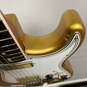 Close-up of the TopHat Stratavarius Aztec Gold Relic guitar, showcasing strings, tremolo bridge, and signature craftsmanship by Chris Fleming.