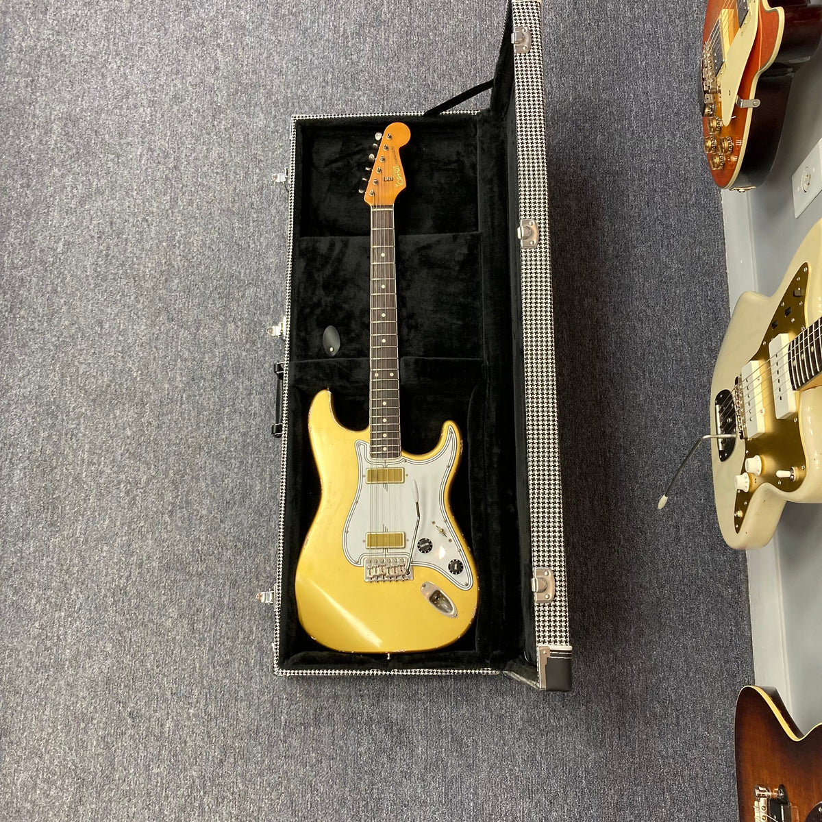 TopHat Stratavarius Aztec Gold Relic electric guitar in a case, featuring a lacquered neck, Callaham tremolo, and Gotoh tuners.