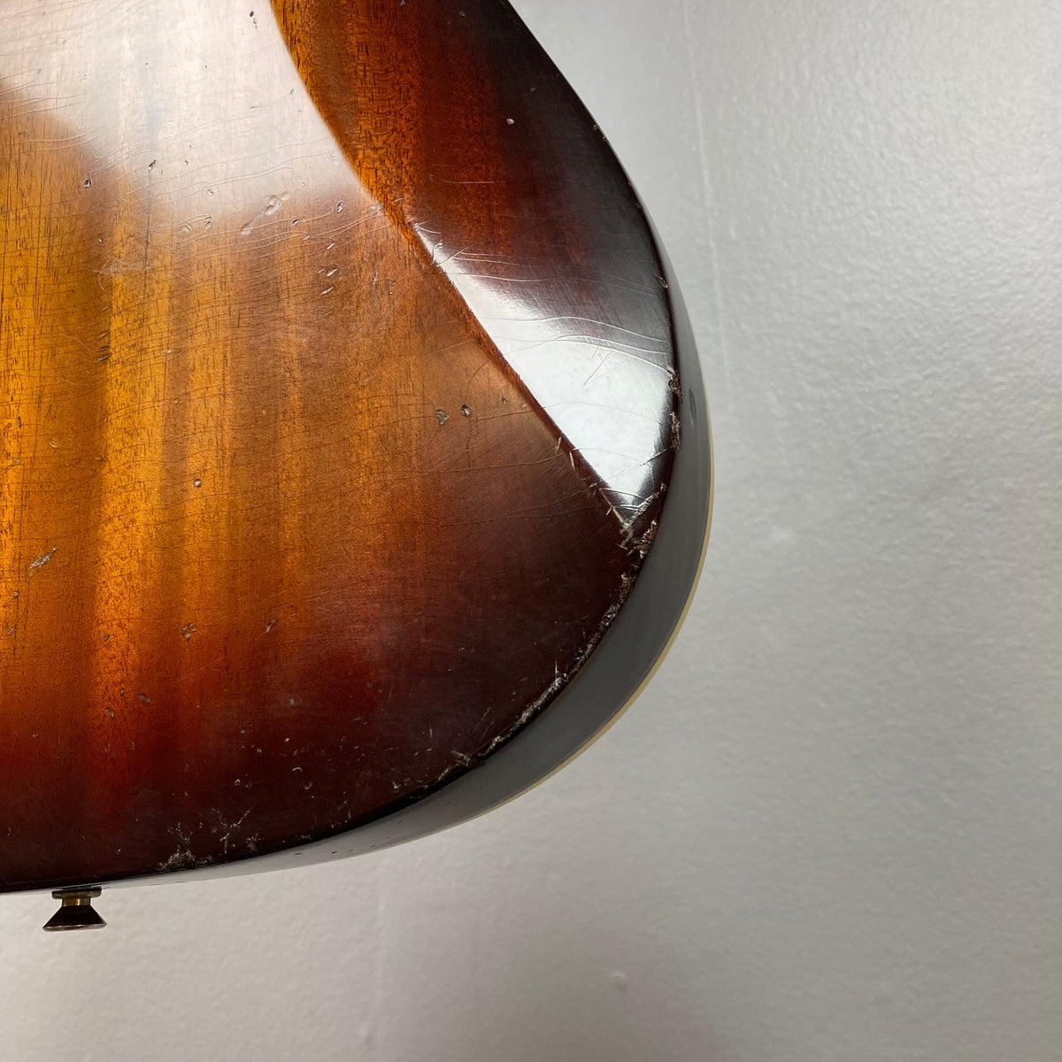 Close-up of the TopHat Telavarius Junior Relic Sunburst guitar, highlighting its single dogear P90 bridge pickup and double-bound mahogany body.