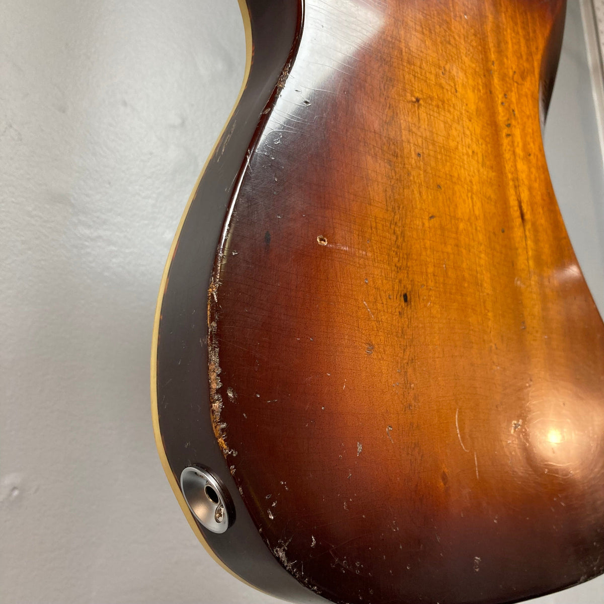 TopHat Telavarius Junior guitar close-up, highlighting its relic design, single dogear P90 pickup, and Faber wraparound bridge.