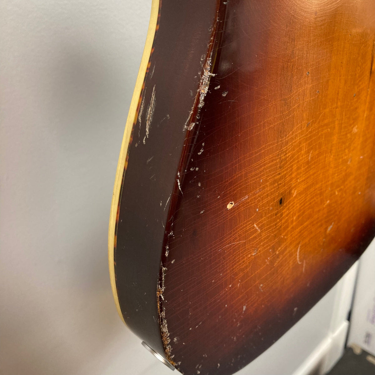 Close-up of the TopHat Telavarius Junior guitar, showcasing its relic design, single dogear P90 pickup, and Faber wraparound bridge.