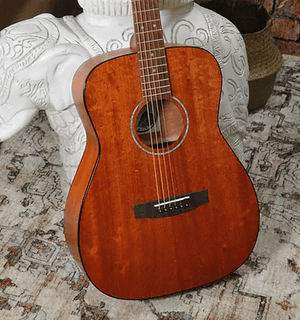 Bodhi BG10M African Okoume Mahogany Top Concert Body Acoustic Guitar displayed on a white statue, showcasing its craftsmanship and compact design.