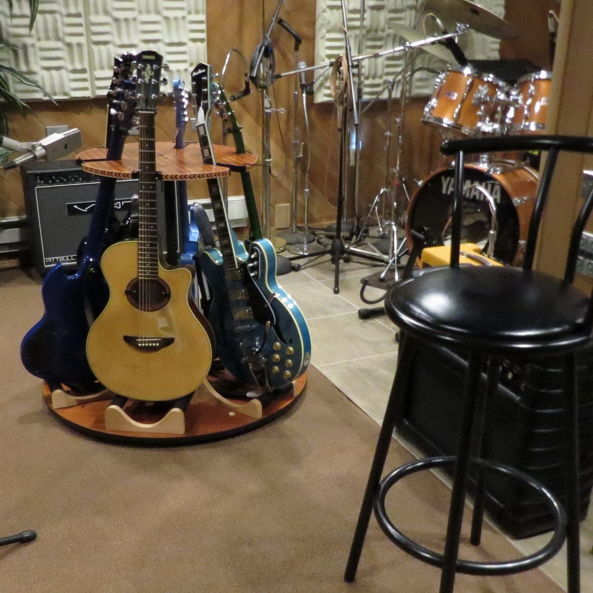 Carousel Deluxe Multi-Guitar Stand showcasing six guitars on a round table, designed for efficient storage and easy 360° access.