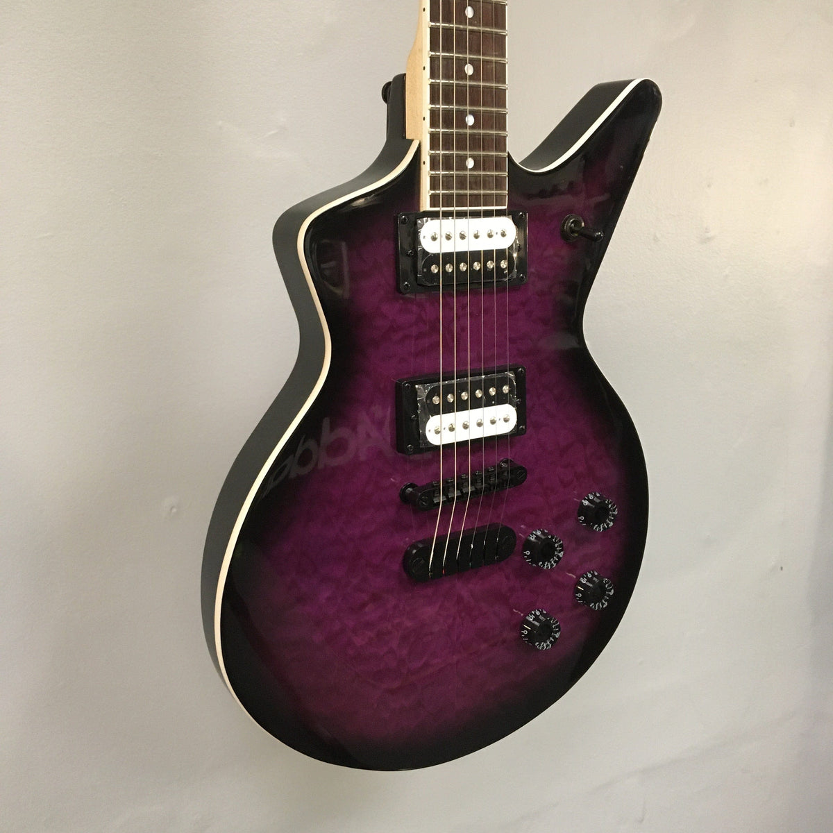 Dean Cadillac X Quilt Maple Trans Purple Burst electric guitar with 22 frets and DMT Designed High Output Zebra Pickups.