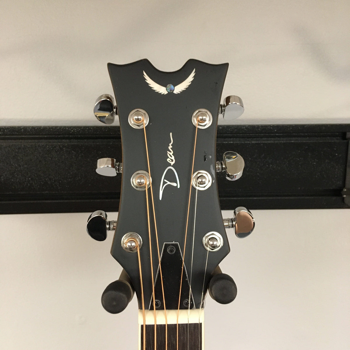 Dean CE Acoustic-Electric Resonator Guitar head with silver pegs, showcasing Grover tuners and partial view of strings, highlighting its modern design and craftsmanship.