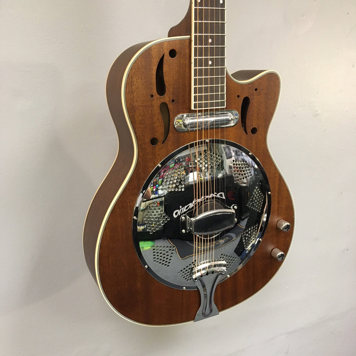 Dean CE Acoustic-Electric Resonator Guitar, close-up of body and silver resonator, featuring eastern mahogany construction and purple heart fingerboard with cutaway design.