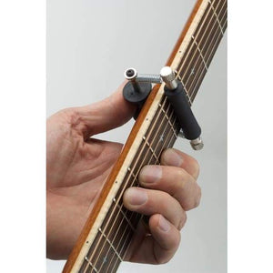 Hand holding guitar neck with Glider Capo, showcasing ease of fret transitions for seamless play.