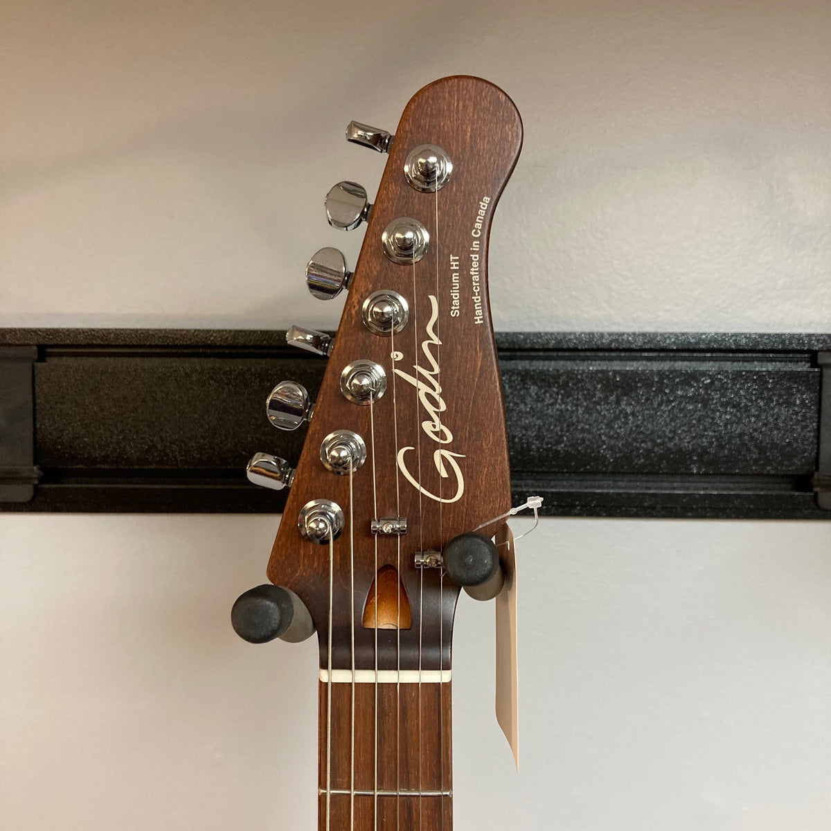 Godin Stadium HT Trans White RN electric guitar with smooth maple neck, basswood body, and Custom T-Ashtray Hardtail Bridge, shown with control knobs and pickups.