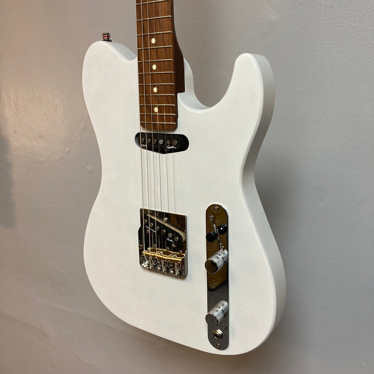 Godin Stadium HT electric guitar with a white body and brown neck, featuring a Custom T-Ashtray bridge and Godin pickups. Includes gig bag.