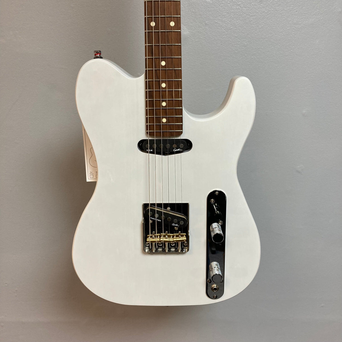 Godin Stadium HT Trans White RN electric guitar featuring a smooth maple neck, custom pickups, and a vintage-style control plate. Includes a gig bag.