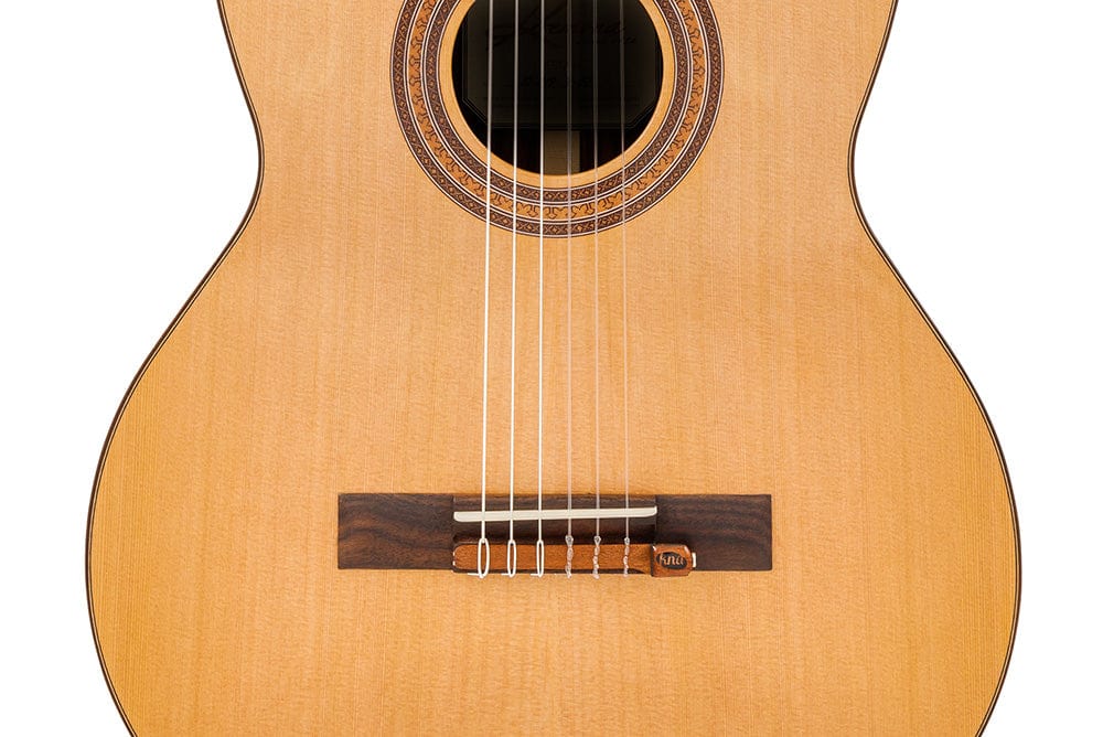 KNA NG-1 Piezo Pick-up installed on a classical guitar, showcasing its secure attachment to the tie block and elegant mahogany casing.