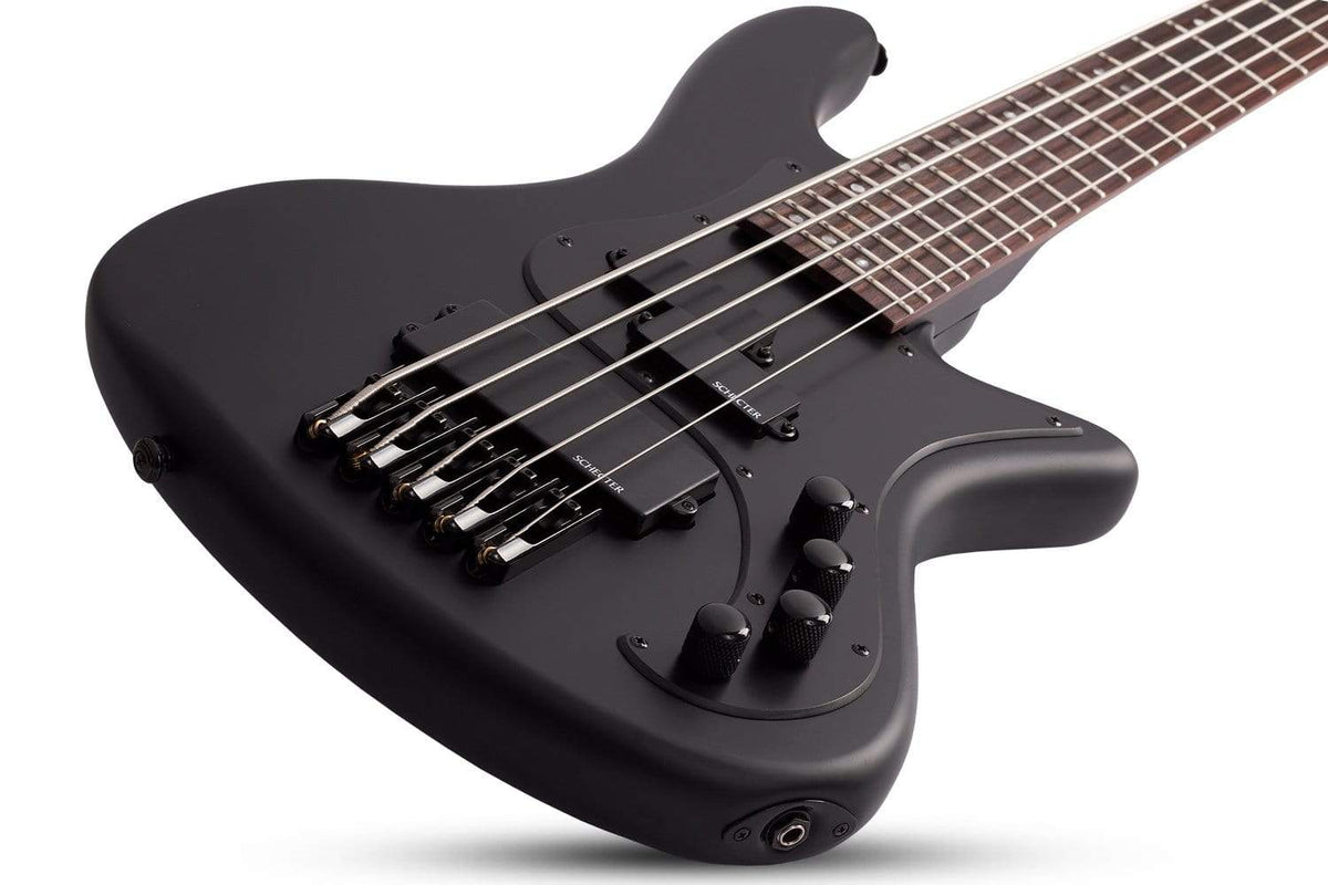 Schecter Stiletto Stealth-5 Satin Black electric bass guitar with strings, featuring a flat top and Schecter tuners, shown close-up.