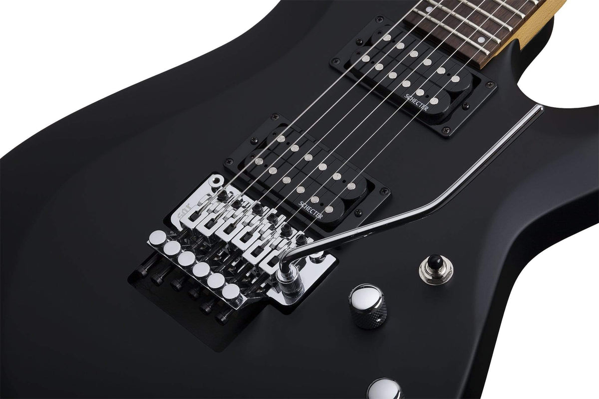 Close-up of the Schecter C-6 FR Deluxe SBK electric guitar, highlighting its detailed craftsmanship and high-quality components.