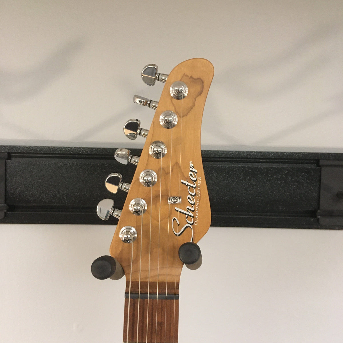 Schecter Nick Johnston Traditional Atomic Ink Open Box guitar head with silver knobs and roasted maple neck, featuring vintage C shape and Schecter locking tuners.