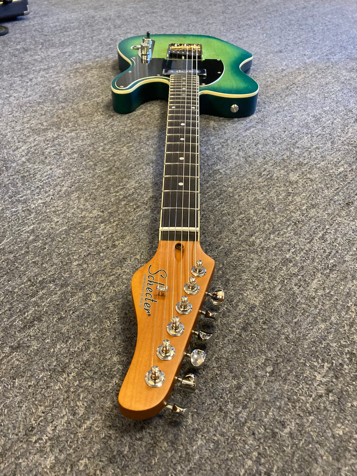 Schecter PT Special Aqua Burst Pearl (AQBP) green electric guitar with Grover vintage tuners and rosewood fretboard, lying on the floor.