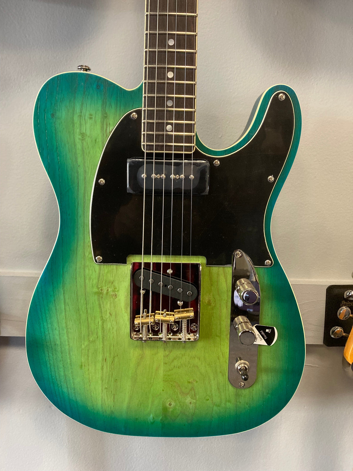 Schecter PT Special Aqua Burst Pearl electric guitar with green and black finish, featuring a rosewood fretboard and Grover Vintage tuners.